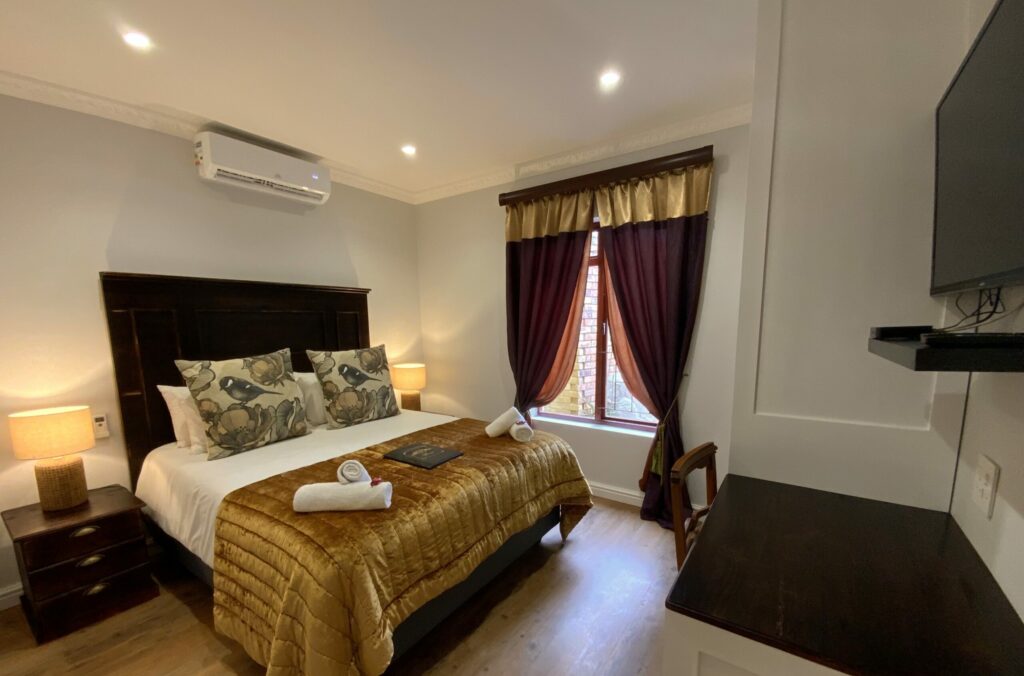 GM room 3 bed desk tv warm copy 2